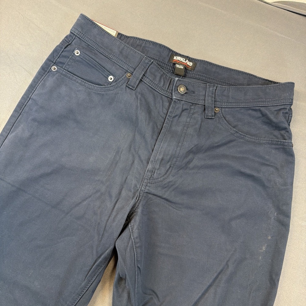 Kirkland Signature men's five-pocket commuter pants in a solid‎ navy blue color